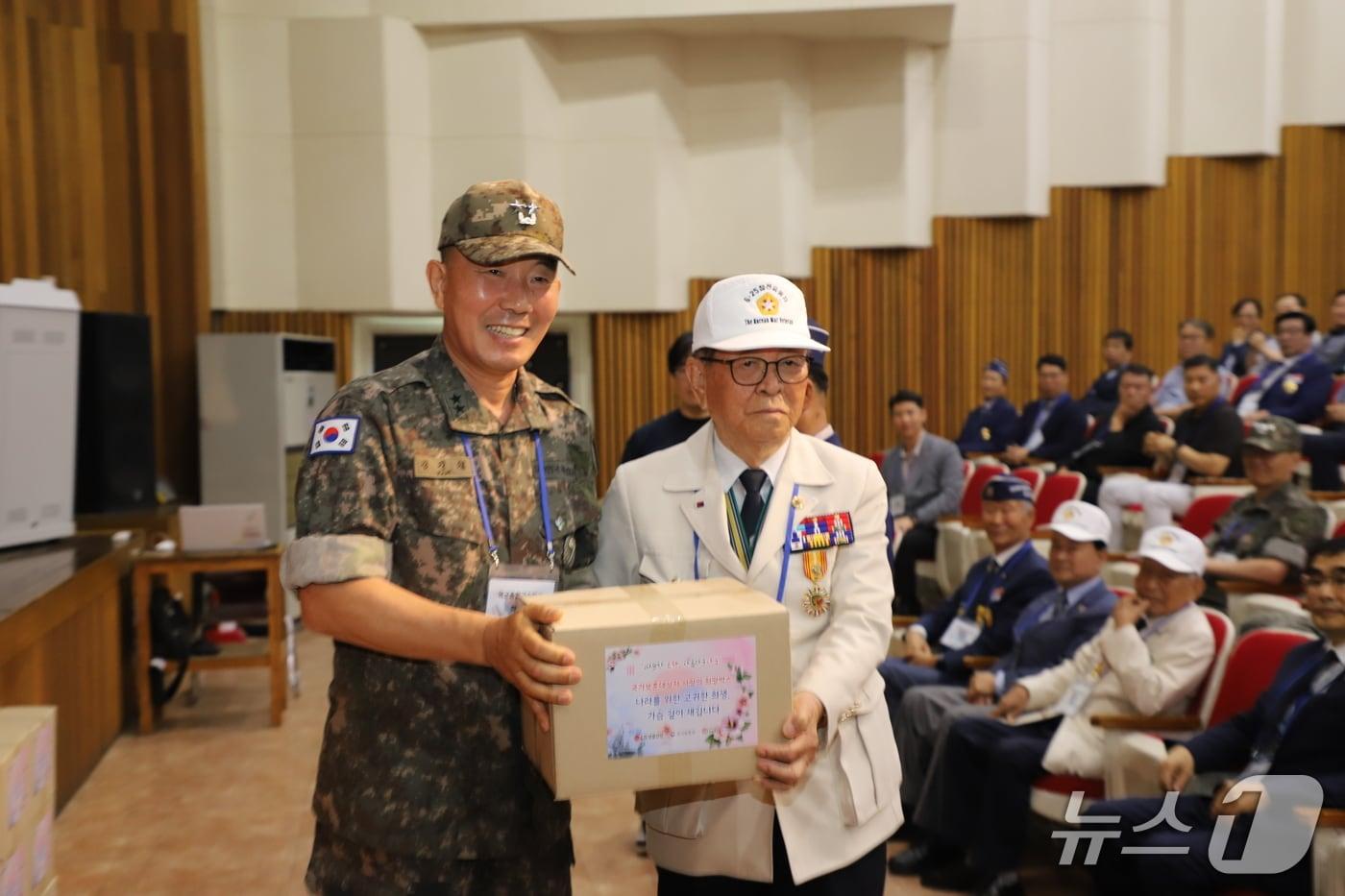본문 이미지 - 김진철 종합군수학교장이 참전용사에게 희망박스와 부대선물을 전달하고 있다.(부대 제공. 재판매 및 DB금지)/뉴스1