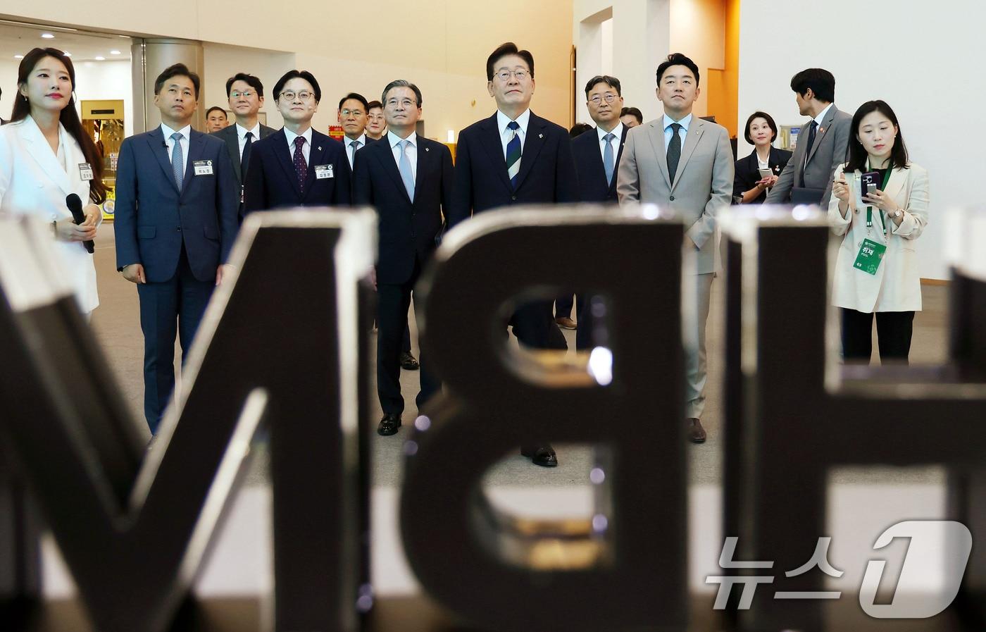 본문 이미지 - 이재명 대통령이 30일 광주 김대중 컨벤션센터에서 열린 서남권 첨단산업 발전비전 국민보고회에서 SK하이닉스 AI반도체 전시물을 관람하고 있다. (청와대통신사진기자단) 2026.6.30 ⓒ 뉴스1 이재명 기자