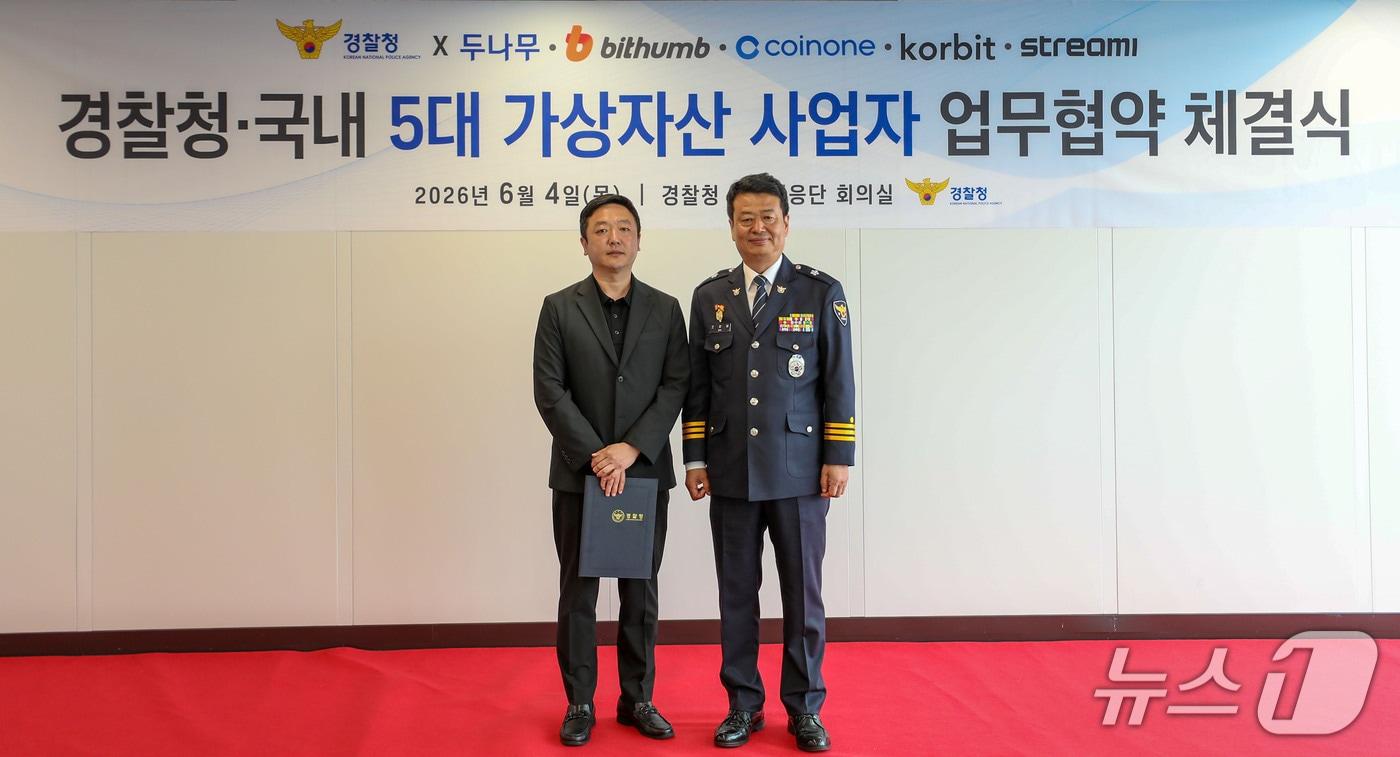 본문 이미지 -  지난 4일  김현진 빗썸 투자자보호실장(왼쪽)과 오창배 경찰청 전기통신금융사기 통합대응단장이 감사장 전달식 후 기념촬영을 하고 있다. 빗썸 제공.