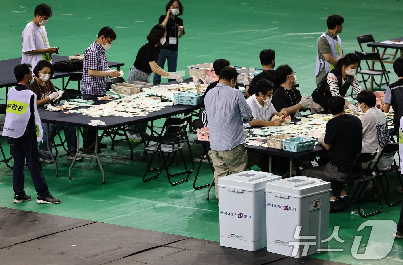 본문 이미지 - 5일 서울 송파구 올림픽공원 핸드볼경기장에서 '투표용지 부족 사태'가 불거져 개표가 미뤄졌던 잠실7동 제2투표소 투표함의 개표가 진행되고 있다. 2026.6.5 ⓒ 뉴스1 김도우 기자