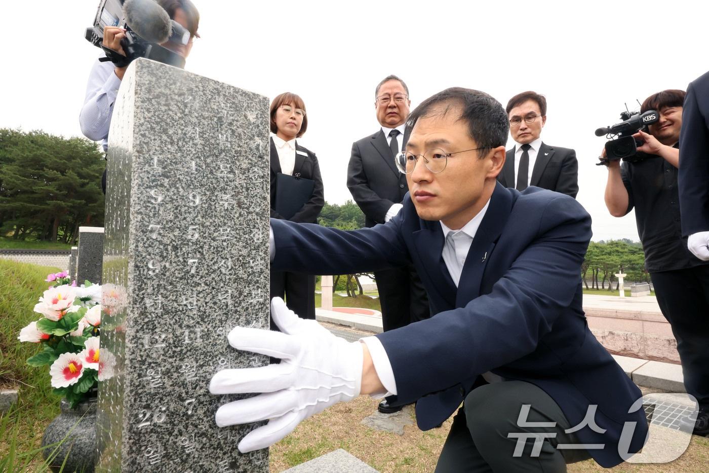 본문 이미지 - 김상욱 울산시장 당선인이 8일 당선증을 가지고 광주 북구 운정동 국립5·18민주묘지를 찾아 윤상원 열사 묘 앞에서 참배한 후 묘비를 닦고 있다. 2026.6.8 ⓒ 뉴스1 박지현 기자