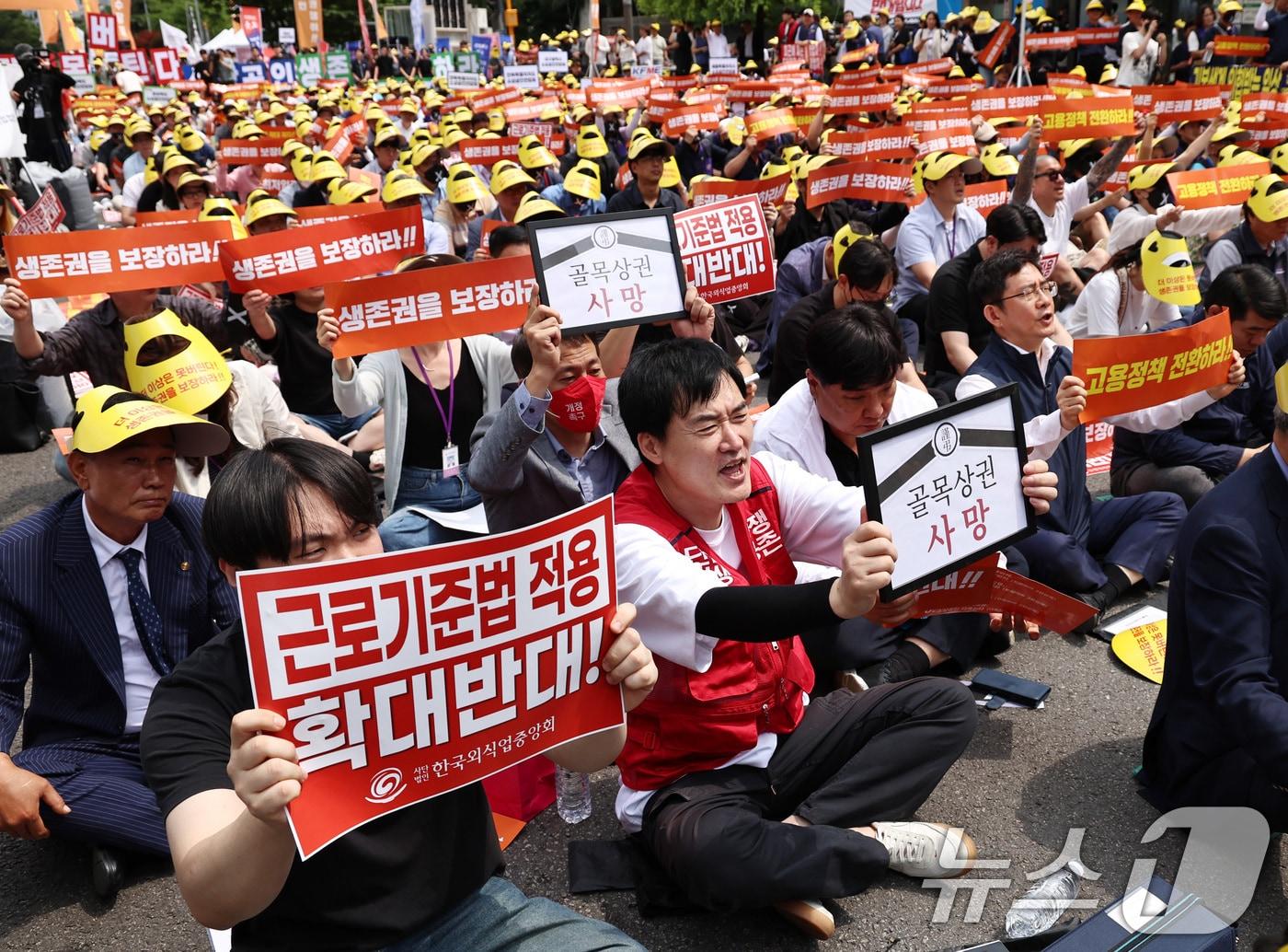 본문 이미지 - 전국에서 모인 소상공인들이 9일 오후 서울 여의도 국회 앞에서 열린 '생존권 사수와 고용정책 대전환 촉구 범소상공인 결의대회'에서 최저임금 구분 적용과 주휴수당 폐지, 대형마트 새벽배송 허용 철회 등을 촉구하며 구호를 외치고 있다. 2026.6.9 ⓒ 뉴스1 구윤성 기자