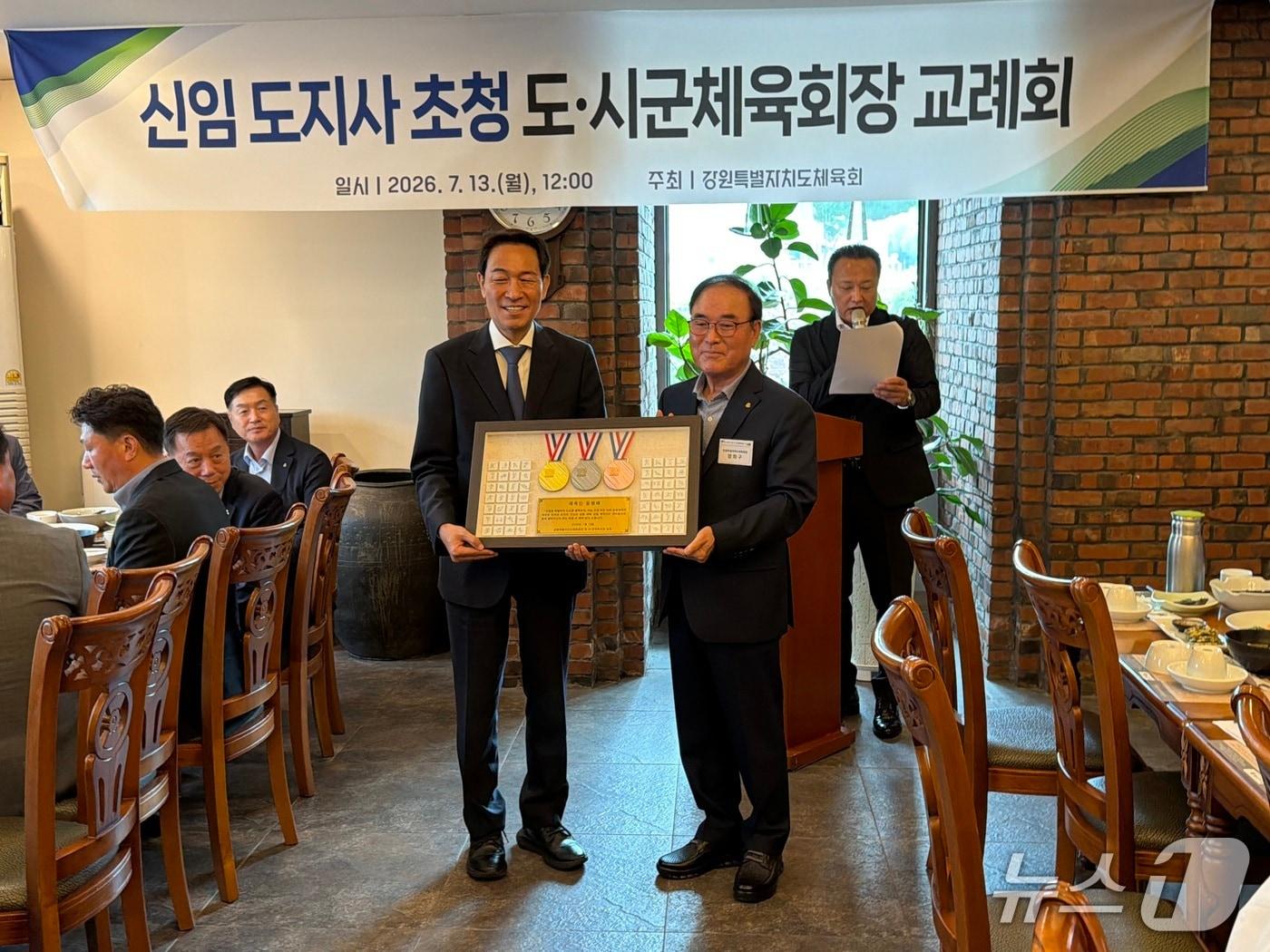 본문 이미지 -  13일 강원 춘천의 한 식당에서 열린 '신임 도지사 초청 도·시군체육회장 교례회'에서 양희구 회장이 우상호 지사에게 '체육인 동행패'를 전달한 뒤 기념촬영을 하고 있다.2026.7.13 한귀섭 기자