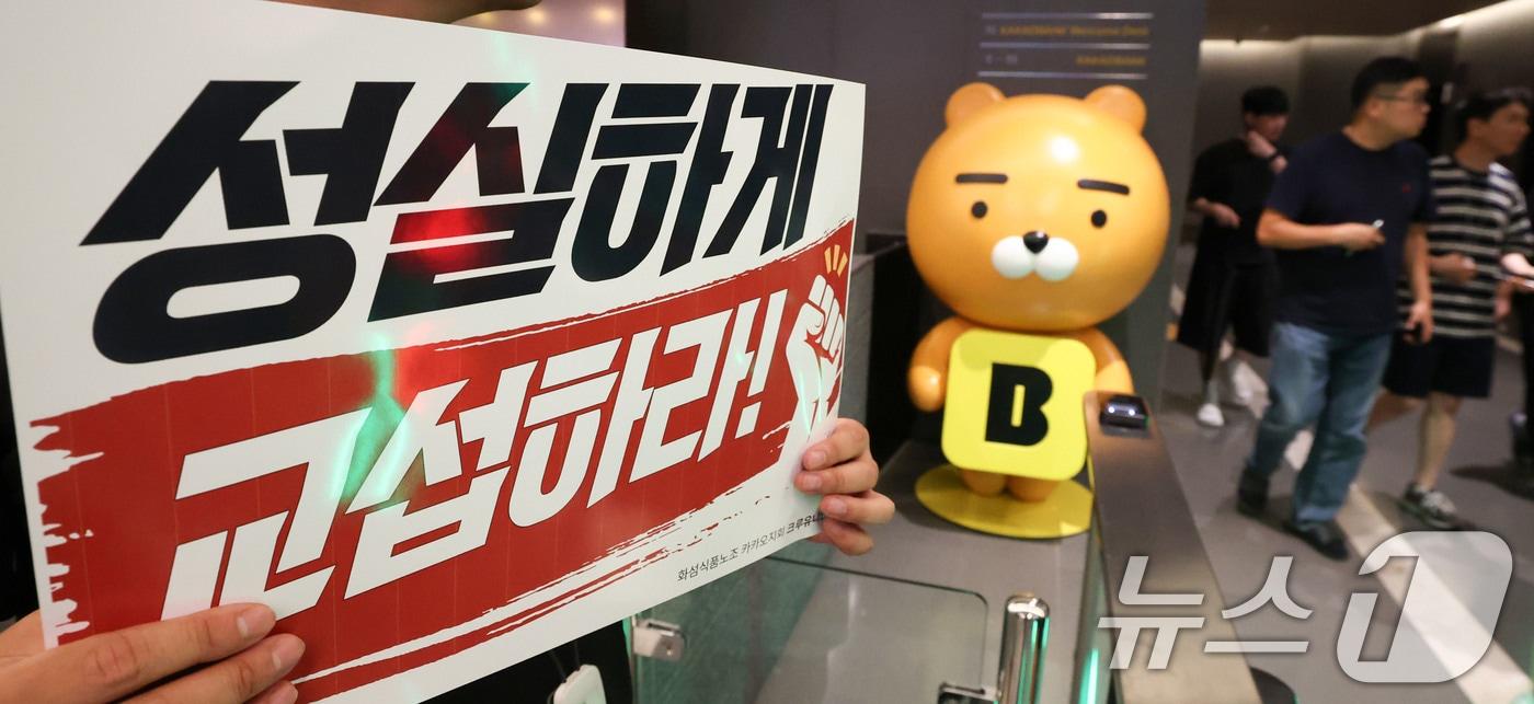 본문 이미지 - 21일 카카오뱅크가 위치한 경기 성남시 판교테크원에서 카카오 노조 조합원이 성과급 보상체계를 둘러싼 사측과의 갈등과 관련해 성실 교섭을 촉구하며 피케팅을 하고 있다. 카카오뱅크 노조는 오는 31일에 전일 파업을 예고했다. 2026.7.21 ⓒ 뉴스1 이종수 기자