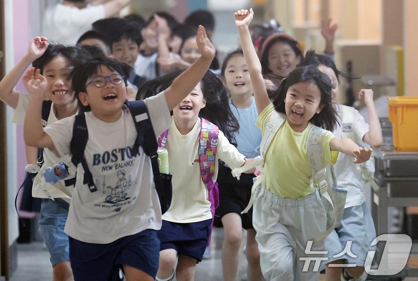 본문 이미지 - 서울지역 초등학교가 여름방학에 들어간 22일 서울 노원구 중평초등학교 2학년 2반 어린이들이 여름 방학식을 마친 뒤 책가방을 메고 하교하며 환호성을 지르고 있다. 2026.7.22 ⓒ 뉴스1 오대일 기자