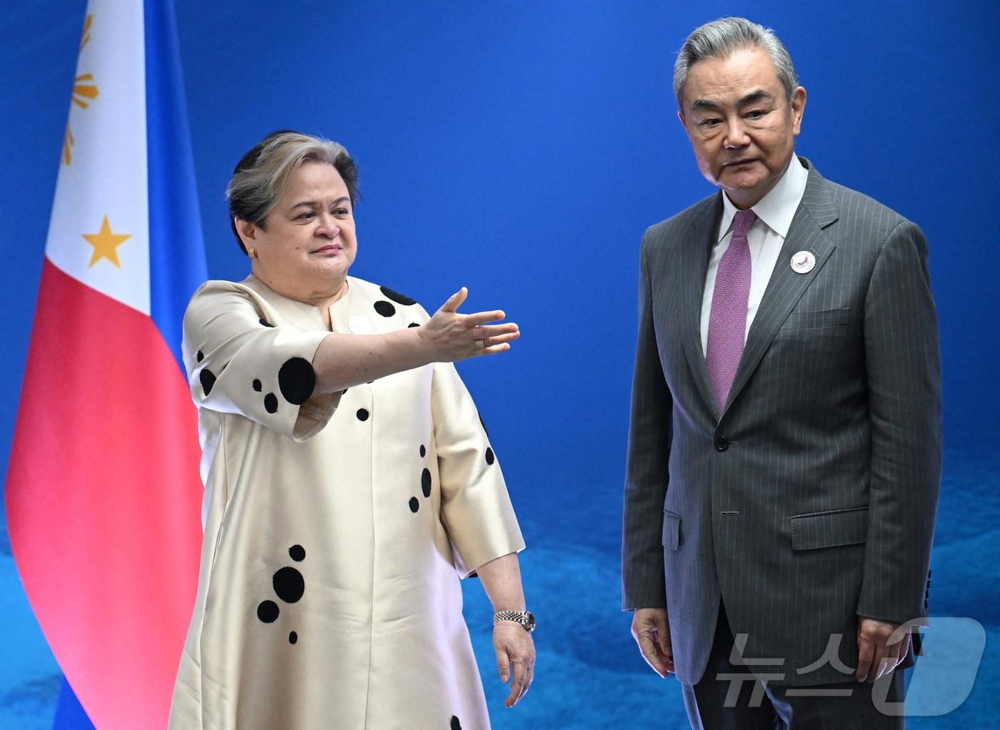 본문 이미지 - 22일(현지시간) 필리핀 메트로마닐라 파사이에서 열린 아세안(ASEAN·동남아시아국가연합) 외교장관회의를 계기로 마리아 테레사 라자로 필리핀 외교장관(왼쪽)과 왕이 중국 외교부장이 만나고 있다. 2026.7.22. ⓒ 로이터=뉴스1