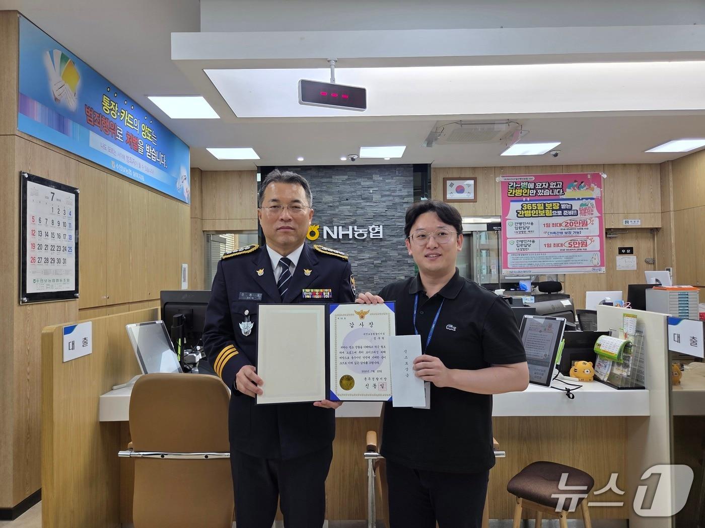 본문 이미지 - 23일 신동일 충주경찰서장이 보이스피싱 피해를 예방한 수안보농협 살미지점 직원 정구혁 씨에게 감사장과 신고포상금을 전달하고 있다.(충주경찰서 제공. 재판매 및 DB금지) 