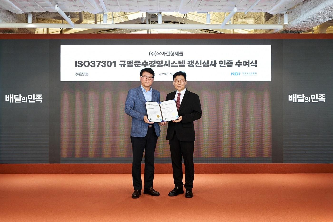 본문 이미지 - 배달의민족 운영사 우아한형제들이 규범준수경영시스템(ISO37301) 인증을 갱신했다. 우아한형제들 이원재 GRC실장(오른쪽)이 한국준법진흥원 이용기 원장으로부터 인증서를 수여받고 있다.(우아한형제들 제공)