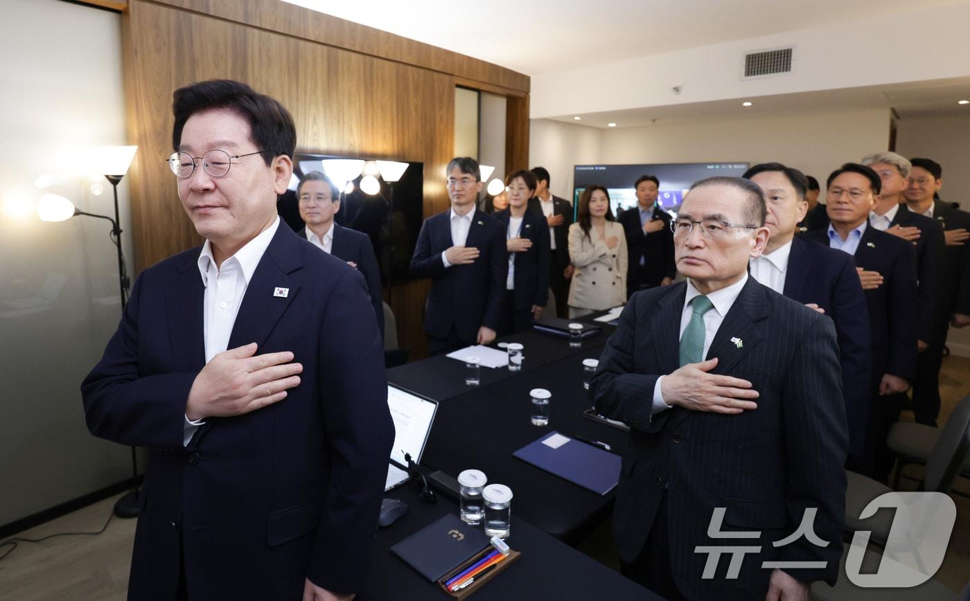 본문 이미지 - 브라질을 국빈 방문한 이재명 대통령이 26일(현지 시간) 브라질리아에서 화상 수석·보좌관회의에서 국민의례를 하고 있다. 2026.7.27 ⓒ 뉴스1 허경 기자