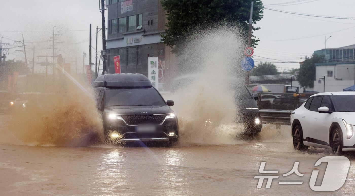 본문 이미지 - 수도권에 많은 비가 내린 9일 경기 오산시의 한 도로가 침수돼 차량이 물보라를 일으키며 주행하고 있다. 2026.7.9 ⓒ 뉴스1 김영운 기자