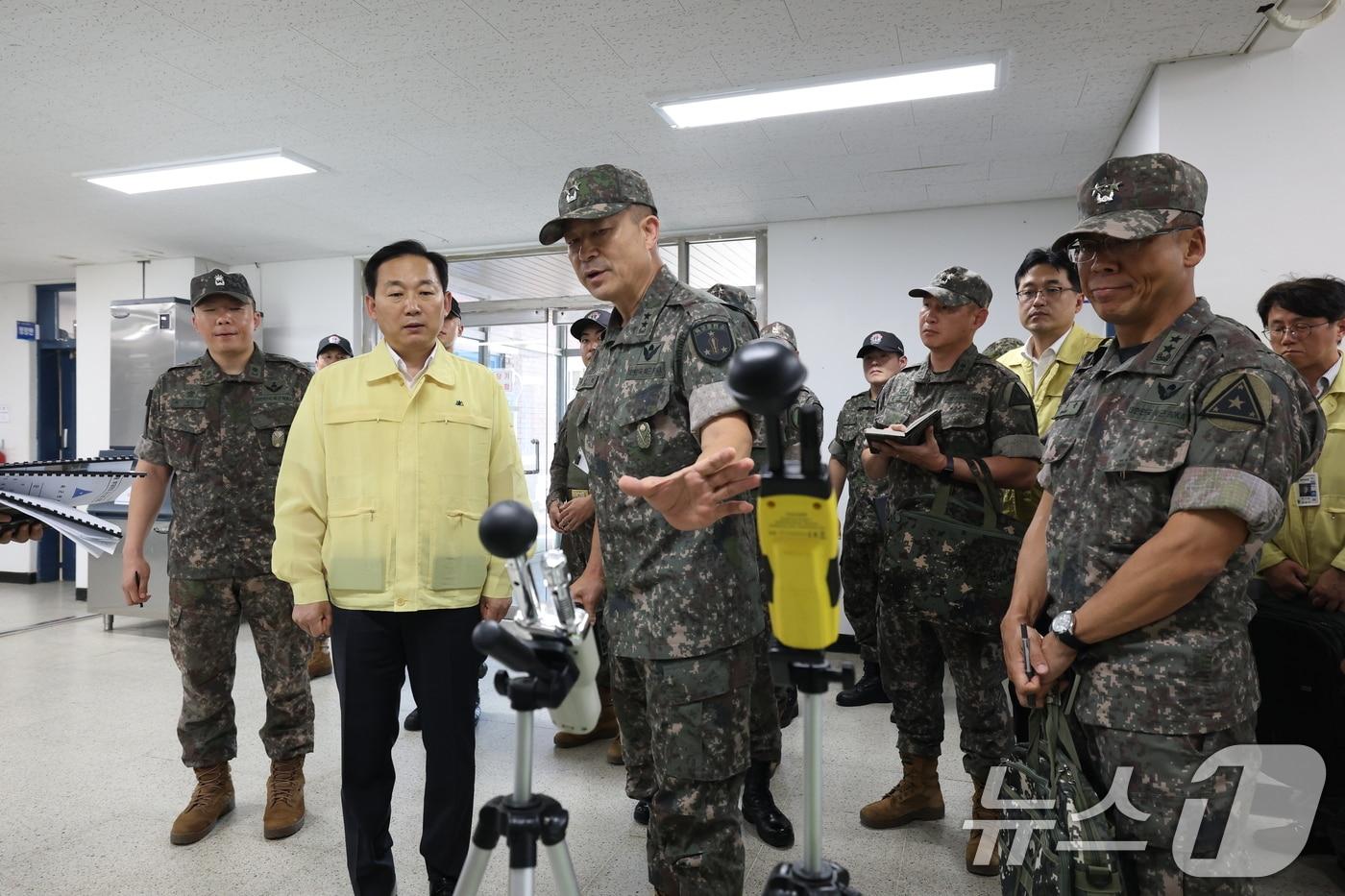 본문 이미지 - 이두희 국방부 차관이 10일 오전 충남 논산 육군훈련소를 방문, ‘폭염중대 경보’에 대비해 혹서기 교육훈련 간 온열질환 예방활동 판단 등에 활용되는 더위체감지수(WBGT) 측정 장비에 대해 설명을 들으며 안전조치를 점검하고 있다. (국방부 제공. 재판매 및 DB금지)