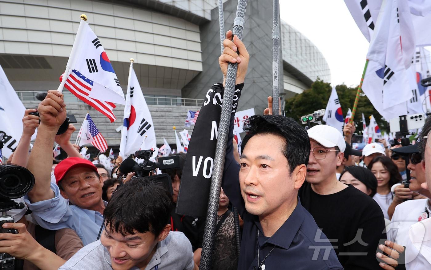 본문 이미지 - 장동혁 국민의힘 대표가 광복절인 15일 서울 송파구 올림픽공원 핸드볼경기장에서 열린 투표 용지 부족 사태 관련 참정권 수호 집회에 태극기를 들고 참석하고 있다. 2026.8.15 ⓒ 뉴스1 김성진 기자
