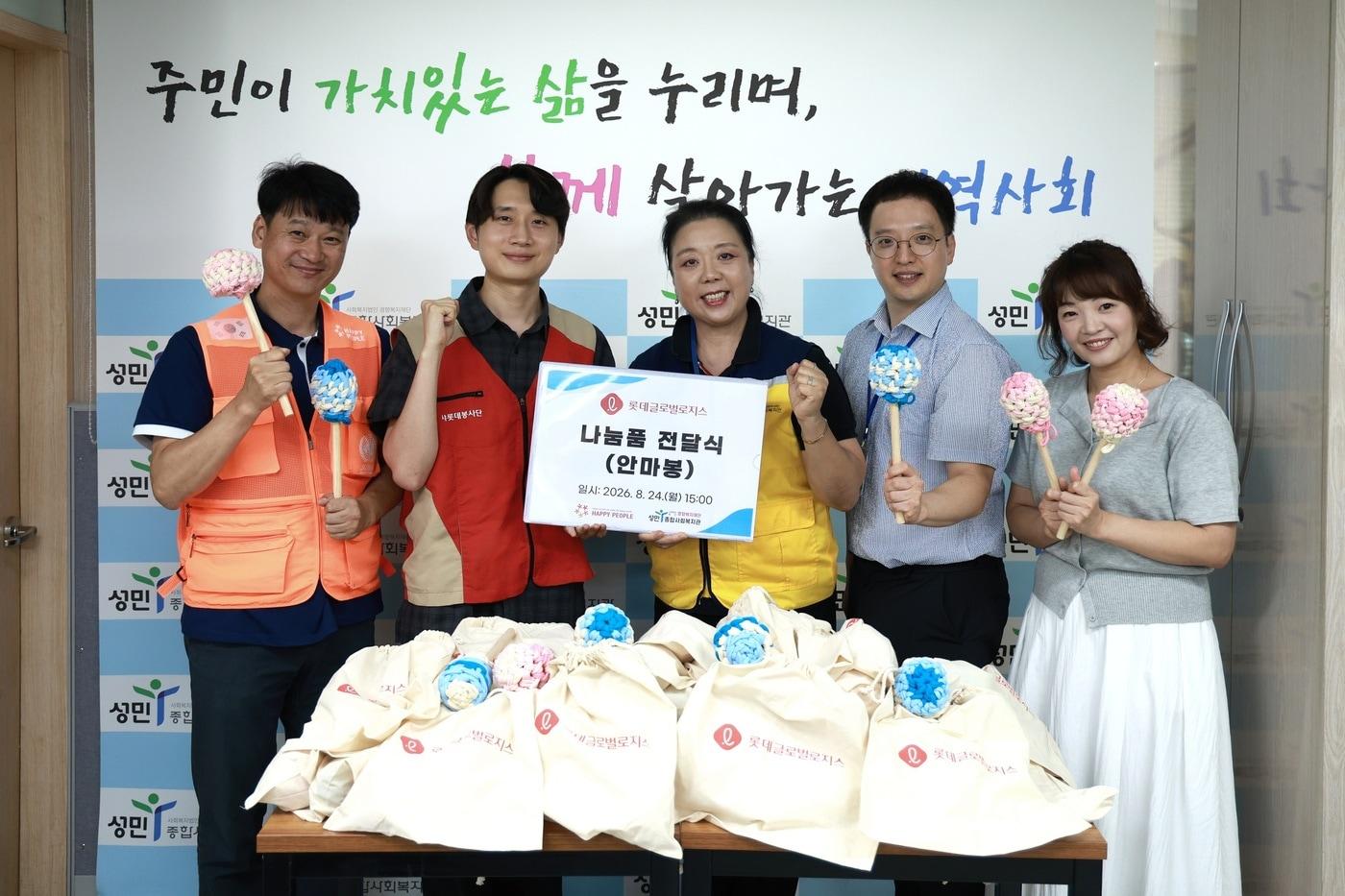 본문 이미지 -  롯데글로벌로지스 임직원들이 폐양말목을 활용해 제작한 '업사이클링 안마봉'을 서울 지역 노인복지센터에 전달했다. (롯데글로벌로지스 제공)