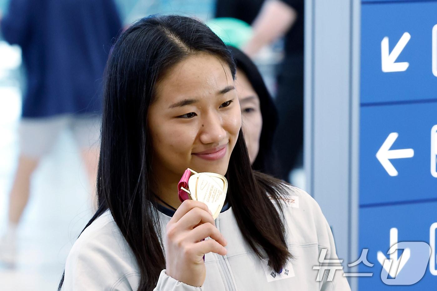 본문 이미지 - 2026 세계배드민턴연맹(BWF) 세계선수권대회 여자 단식을 제패한 안세영이 25일 오전 인천국제공항을 통해 귀국해 우승 메달을 들어 보이고 있다.  ⓒ 뉴스1 박정호 기자