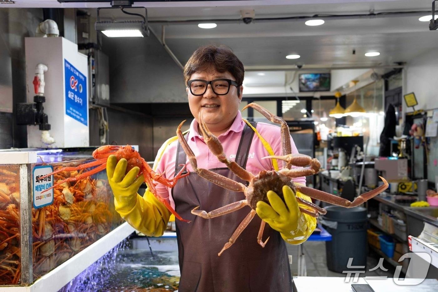 본문 이미지 - 속초관광수산시장 '예스수산'의 남상훈 사장이 쿠팡이츠와의 인터뷰에서 기념촬영을 하고 있다(쿠팡이츠 제공). 2026.8.3/뉴스1