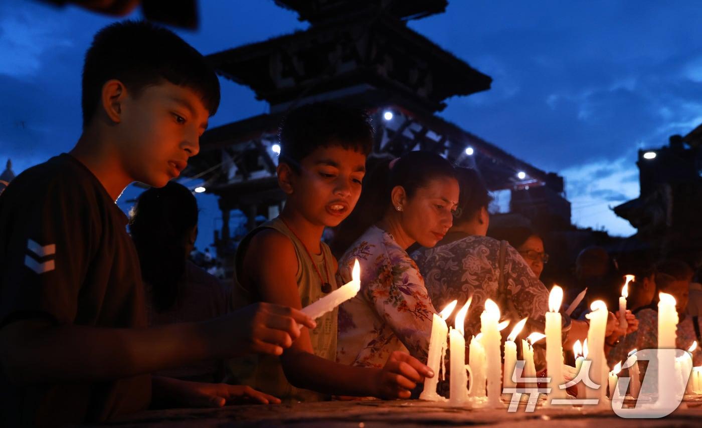 본문 이미지 - 대규모 홍수 참사 13일째를 맞아 네팔 정부가 '국가 애도의 날'로 지정한 7일(현지시간) 카트만두 더르바르 광장에서 시민들이 희생자들을 추모하며 촛불을 밝히고 있다. 2026.9.7 ⓒ 뉴스1 구윤성 기자