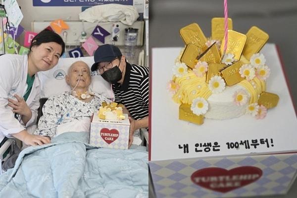 본문 이미지 - 구민정 서울아산병원 심장혈관흉부외과 교수(왼쪽)와 이승만 환자·보호자가 수술 후 병실에서 맞은 이 씨의 100번째 생일을 축하하며 기념촬영을 하고 있다. 오른쪽은 구 교수가 준비한 이 씨의 생일 축하 케이크. (병원 제공)