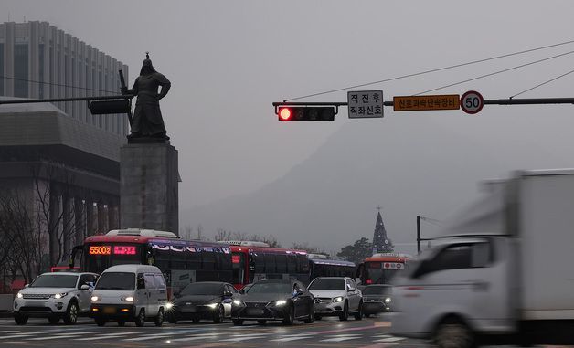 뿌연 도심에 전조등 켠 차량들