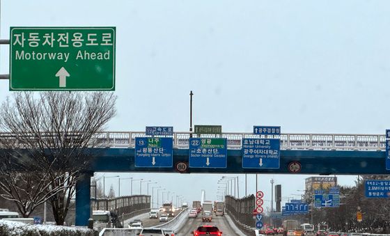 눈길에 거북이 주행하는 차량들