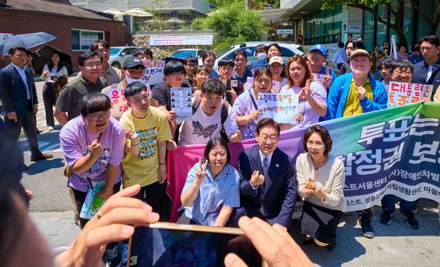장애인단체와 기념촬영하는 이재명 대통령 부부
