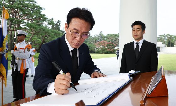 참배 마치고 방명록 작성하는 김민석 전 총리