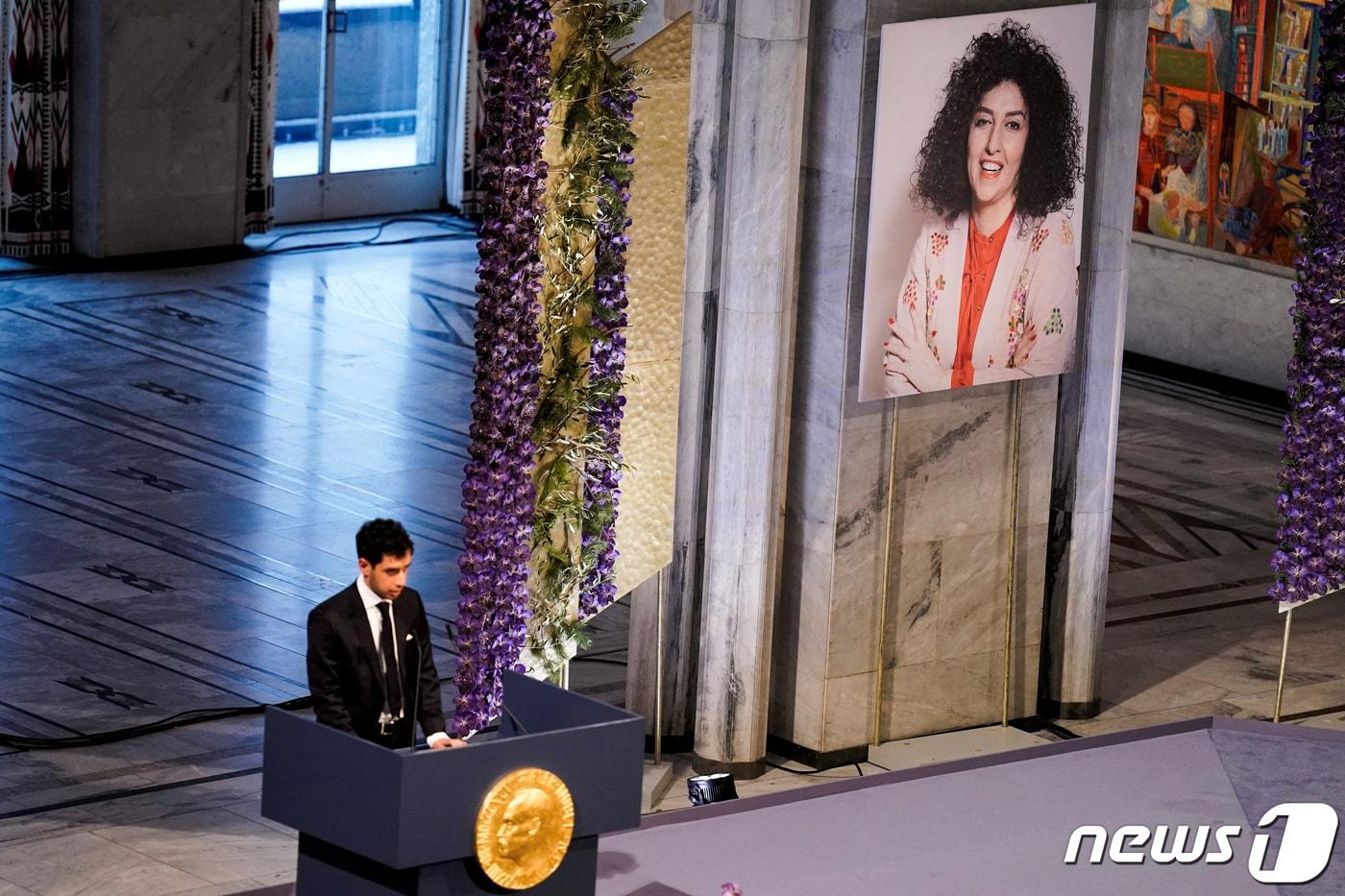 옥중에서 올해 노벨평화상 수상자로 선정된 이란 인권운동가 나르게스 모하마디(51·오른쪽 사진)를 대신해 그의 17세 아들 알리가 대리 수상하며 소감문을 대독하고 있다. 2023.12.10/ ⓒ 로이터=뉴스1 ⓒ News1 박재하 기자